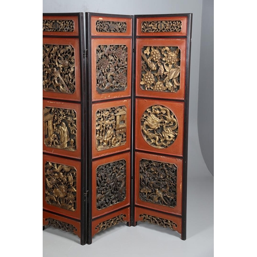 509 - A CHINESE CARVED AND LACQUERED SIX FOLD SCREEN. early 20th century, each red and black lacquered pan... 