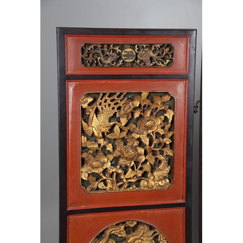 509 - A CHINESE CARVED AND LACQUERED SIX FOLD SCREEN. early 20th century, each red and black lacquered pan... 