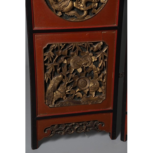 509 - A CHINESE CARVED AND LACQUERED SIX FOLD SCREEN. early 20th century, each red and black lacquered pan... 