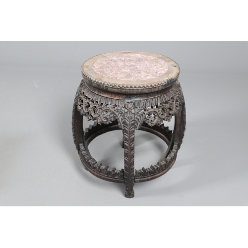 510 - A CHINESE HARDWOOD JARDINIERE STAND. early 20th century, the top inset with pink marble upon an intr... 