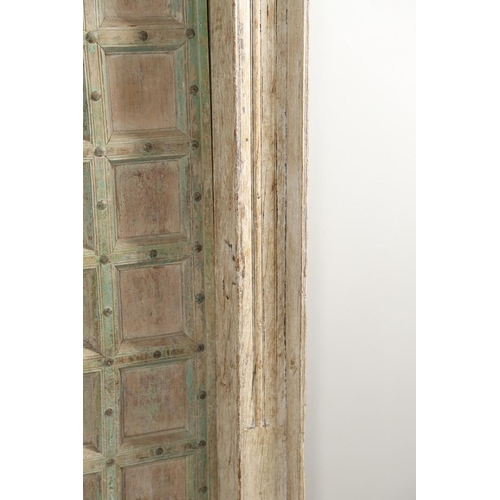 512 - A PAIR OF INDIAN PAINTED HARDWOOD DOORS. 20th century, each door panelled and metal studded with iro... 