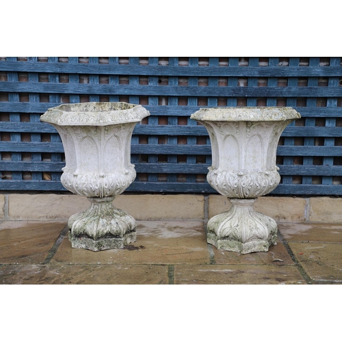 513 - A PAIR OF FRENCH PAINTED BUFF TERRACOTTA URNS. of Gothic architectural form, the octagonal rims to r... 