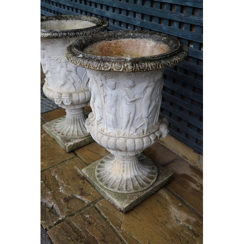 514 - A PAIR OF PAINTED COMPOSITE MARBLE MEDICI STYLE URNS. with relief classical decoration, on fluted so... 