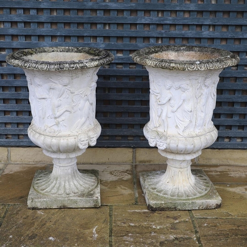 514 - A PAIR OF PAINTED COMPOSITE MARBLE MEDICI STYLE URNS. with relief classical decoration, on fluted so... 