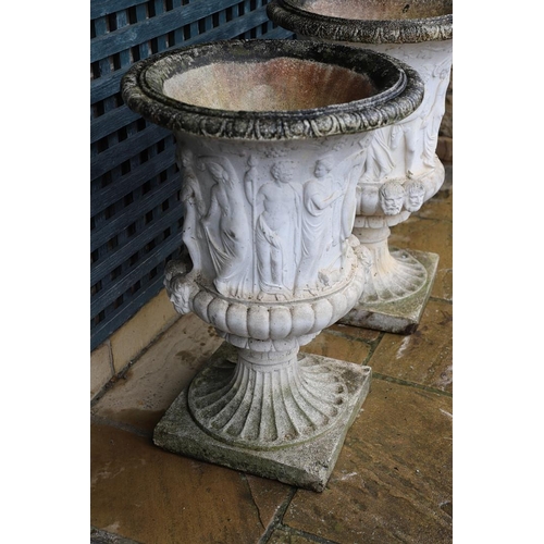 514 - A PAIR OF PAINTED COMPOSITE MARBLE MEDICI STYLE URNS. with relief classical decoration, on fluted so... 