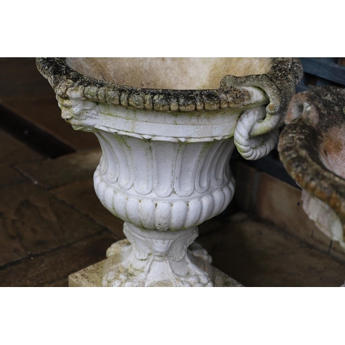 515 - A PAIR OF PAINTED COMPOSITE MARBLE CAMPANA STYLE URNS. the flaring, fluted body with a pair of rope ... 