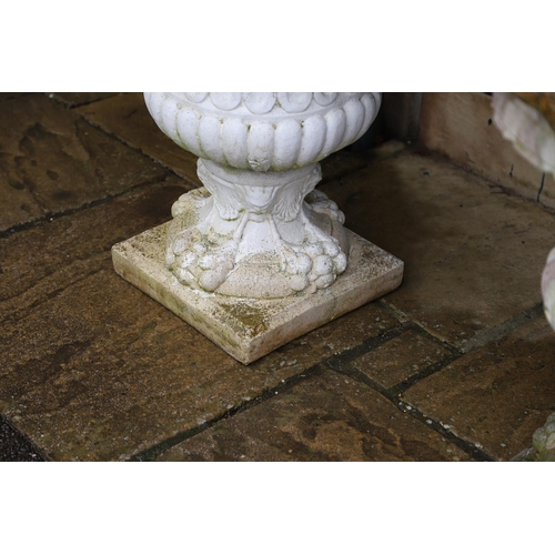 515 - A PAIR OF PAINTED COMPOSITE MARBLE CAMPANA STYLE URNS. the flaring, fluted body with a pair of rope ... 