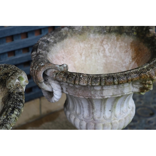 515 - A PAIR OF PAINTED COMPOSITE MARBLE CAMPANA STYLE URNS. the flaring, fluted body with a pair of rope ... 