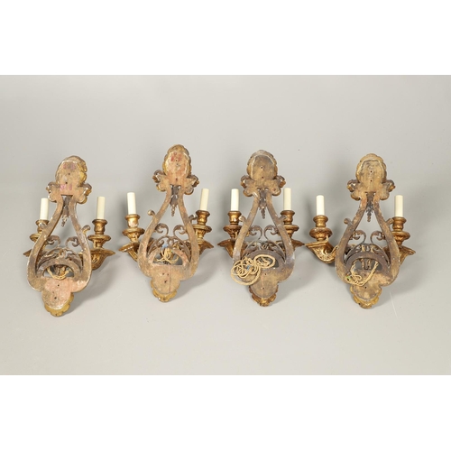 517 - A SET OF FOUR 19TH CENTURY GILT GESSO TWIN BRANCH WALL LIGHTS. with carved shell to crest and base t... 