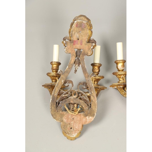 517 - A SET OF FOUR 19TH CENTURY GILT GESSO TWIN BRANCH WALL LIGHTS. with carved shell to crest and base t... 