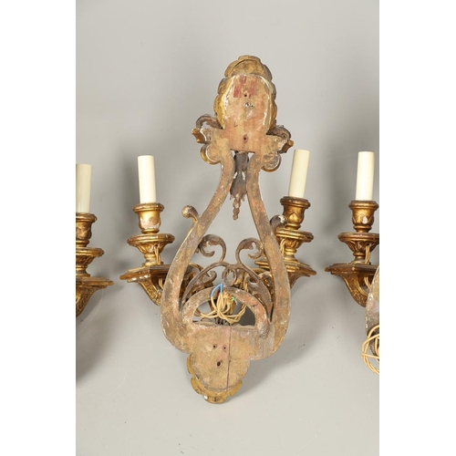 517 - A SET OF FOUR 19TH CENTURY GILT GESSO TWIN BRANCH WALL LIGHTS. with carved shell to crest and base t... 