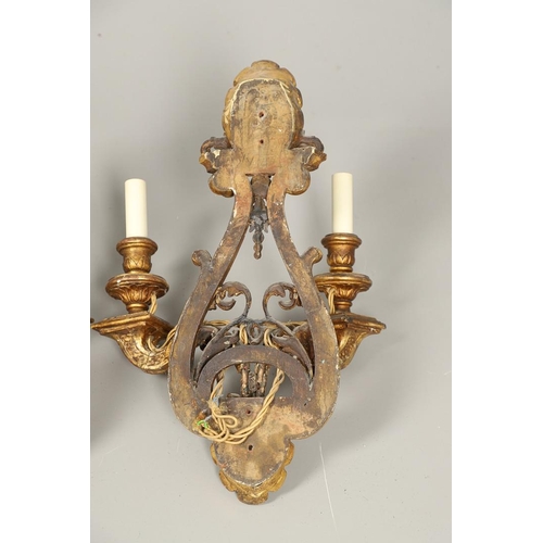 517 - A SET OF FOUR 19TH CENTURY GILT GESSO TWIN BRANCH WALL LIGHTS. with carved shell to crest and base t... 