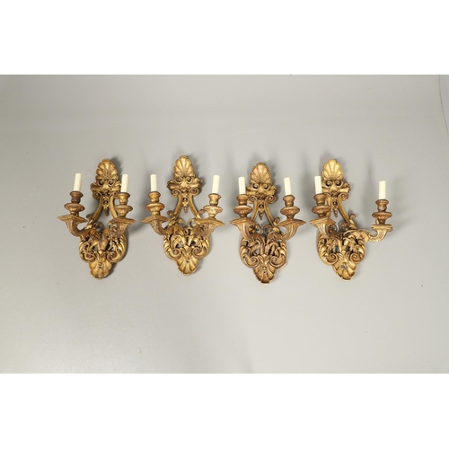 517 - A SET OF FOUR 19TH CENTURY GILT GESSO TWIN BRANCH WALL LIGHTS. with carved shell to crest and base t... 