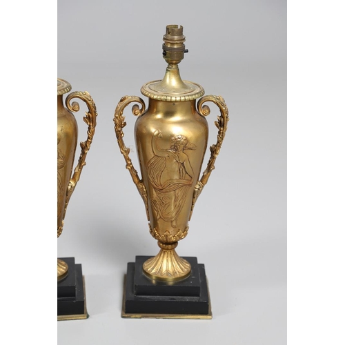 518 - A PAIR OF LATE 19TH/EARLY 20TH CENTURY GILT METAL TABLE LAMPS. modelled as Classical urns, each with... 