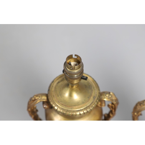 518 - A PAIR OF LATE 19TH/EARLY 20TH CENTURY GILT METAL TABLE LAMPS. modelled as Classical urns, each with... 