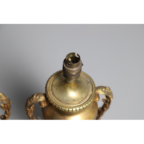 518 - A PAIR OF LATE 19TH/EARLY 20TH CENTURY GILT METAL TABLE LAMPS. modelled as Classical urns, each with... 