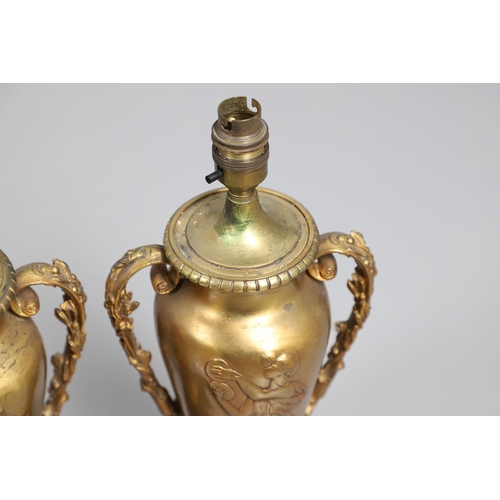 518 - A PAIR OF LATE 19TH/EARLY 20TH CENTURY GILT METAL TABLE LAMPS. modelled as Classical urns, each with... 