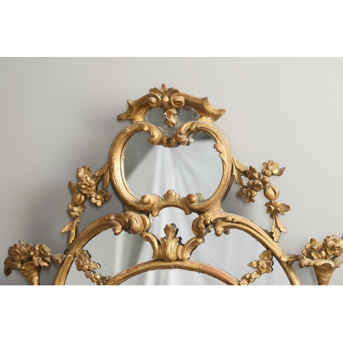 519 - A LATE 18TH CENTURY GILTWOOD SECTIONAL WALL MIRROR. the ornate frame carved in the Rococo style as f... 