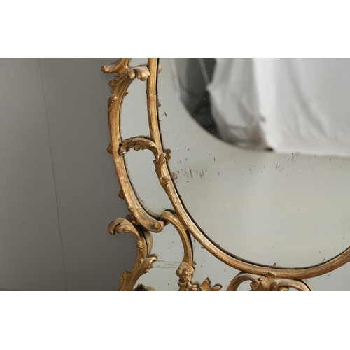 519 - A LATE 18TH CENTURY GILTWOOD SECTIONAL WALL MIRROR. the ornate frame carved in the Rococo style as f... 