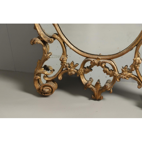 519 - A LATE 18TH CENTURY GILTWOOD SECTIONAL WALL MIRROR. the ornate frame carved in the Rococo style as f... 