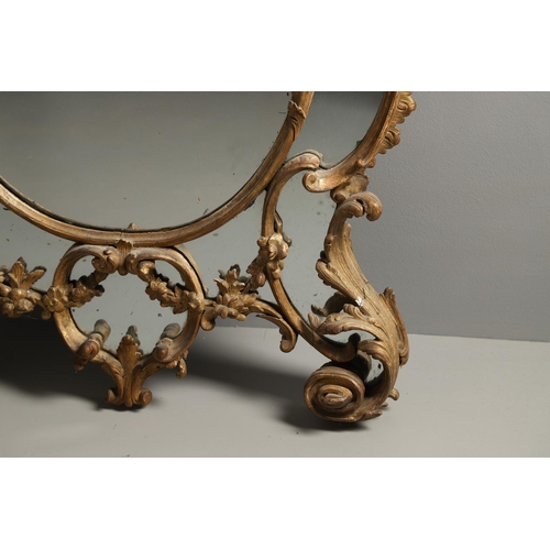 519 - A LATE 18TH CENTURY GILTWOOD SECTIONAL WALL MIRROR. the ornate frame carved in the Rococo style as f... 