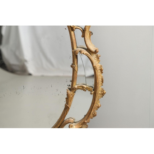 519 - A LATE 18TH CENTURY GILTWOOD SECTIONAL WALL MIRROR. the ornate frame carved in the Rococo style as f... 