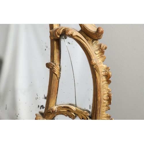 519 - A LATE 18TH CENTURY GILTWOOD SECTIONAL WALL MIRROR. the ornate frame carved in the Rococo style as f... 