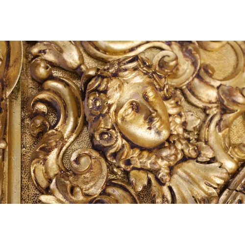 521 - A SUBSTANTIAL ITALIAN GILT GESSO MIRROR. early 20th century, the oval bevelled plate to a heavily mo... 