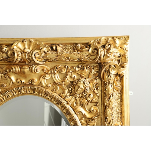 521 - A SUBSTANTIAL ITALIAN GILT GESSO MIRROR. early 20th century, the oval bevelled plate to a heavily mo... 