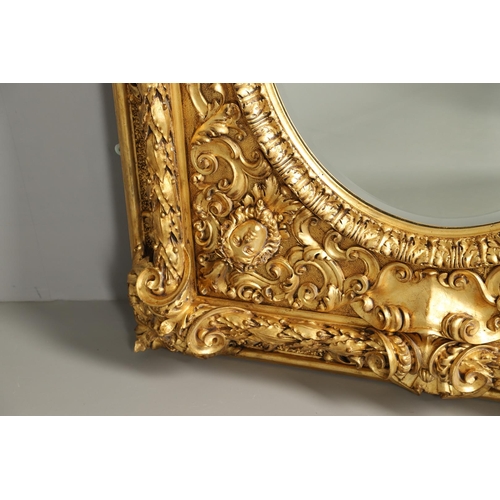 521 - A SUBSTANTIAL ITALIAN GILT GESSO MIRROR. early 20th century, the oval bevelled plate to a heavily mo... 