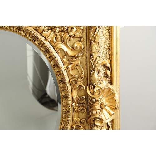 521 - A SUBSTANTIAL ITALIAN GILT GESSO MIRROR. early 20th century, the oval bevelled plate to a heavily mo... 