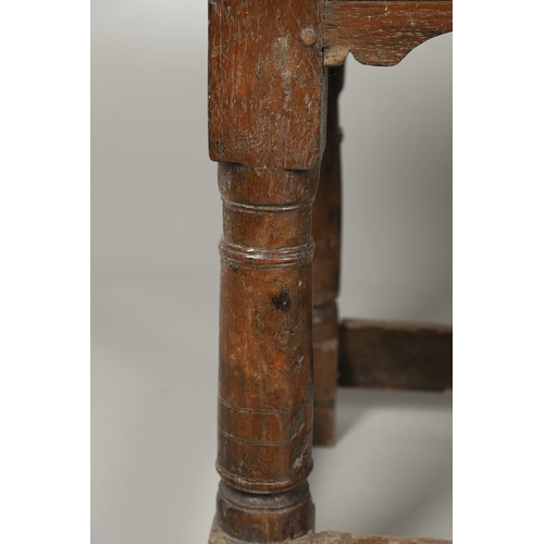 523 - A 17TH CENTURY AND LATER OAK REFECTORY TABLE. the four plank top over a carved frieze apron,  stretc... 