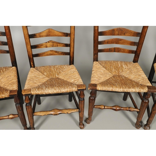 524 - A MATCHED SET OF EIGHT ELM AND ASH LADDERBACK CHAIRS. early 19th century, comprising six singles and... 