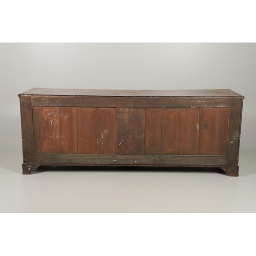 526 - A GEORGE III OAK DRESSER BASE. the double plank top over seven drawers and central shelved ogee pane... 