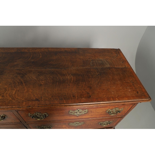 526 - A GEORGE III OAK DRESSER BASE. the double plank top over seven drawers and central shelved ogee pane... 