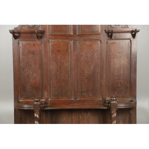 529 - A LARGE CARVED OAK COUNTRY HOUSE HALLSTAND. with a shaped cornice and panel back, carved Lion masks ... 