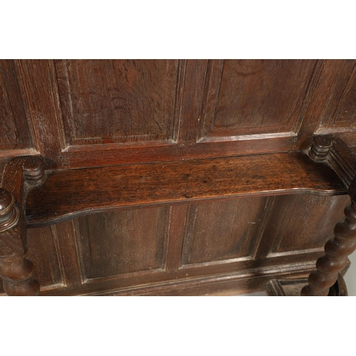 529 - A LARGE CARVED OAK COUNTRY HOUSE HALLSTAND. with a shaped cornice and panel back, carved Lion masks ... 