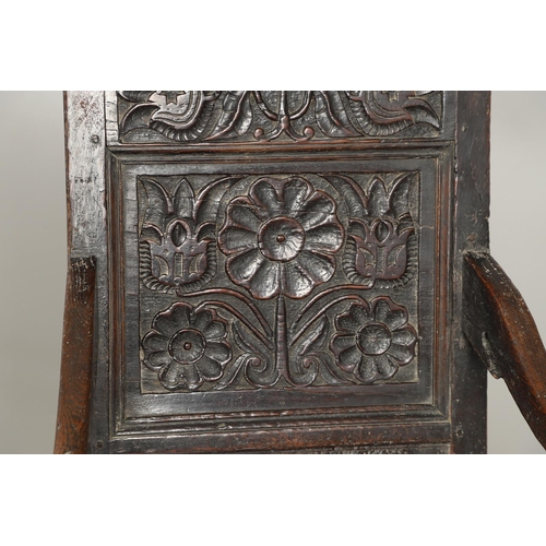 530 - A 17TH CENTURY OAK WAINSCOTT CHAIR. the back with relief-carved frieze and panel of multiple flowers... 