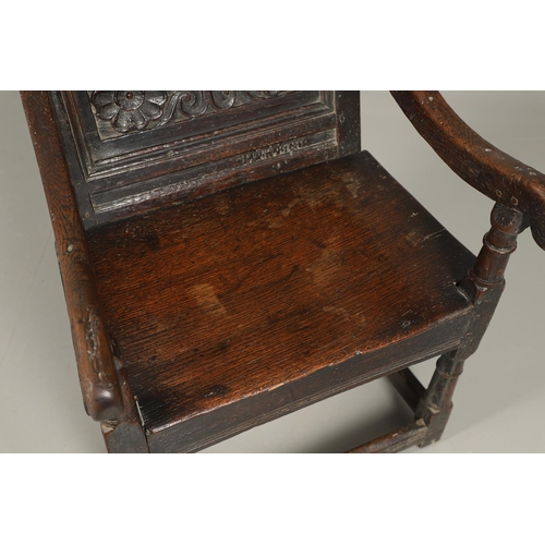 530 - A 17TH CENTURY OAK WAINSCOTT CHAIR. the back with relief-carved frieze and panel of multiple flowers... 