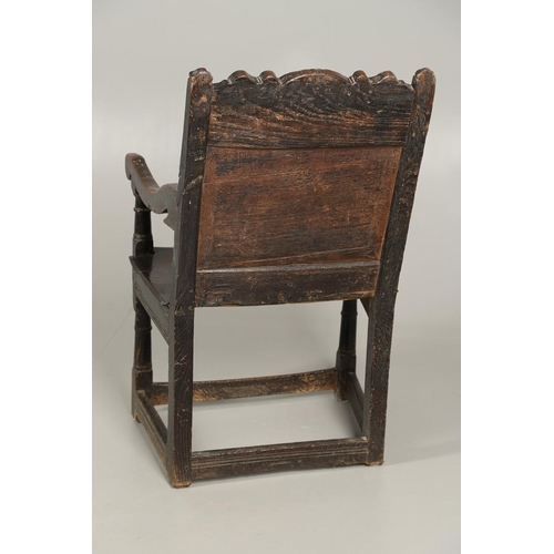 530 - A 17TH CENTURY OAK WAINSCOTT CHAIR. the back with relief-carved frieze and panel of multiple flowers... 