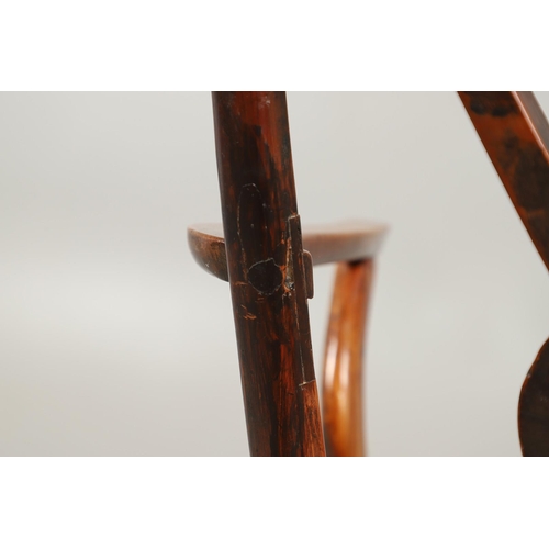 531 - A YEW AND ELM WINDSOR ELBOW CHAIR. early 19th century, Buckingham or Oxford, the cross and roundel b... 