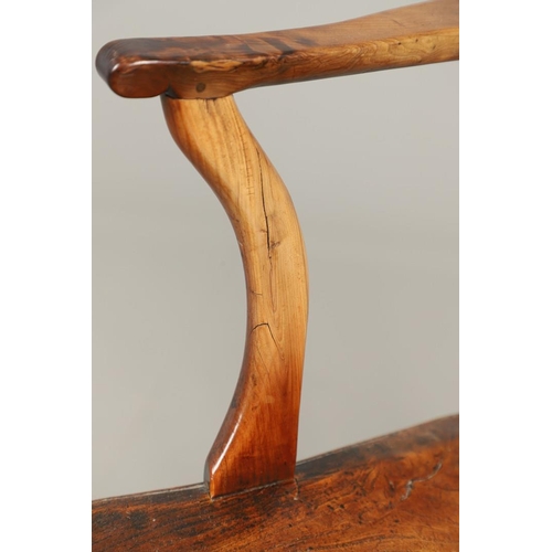 531 - A YEW AND ELM WINDSOR ELBOW CHAIR. early 19th century, Buckingham or Oxford, the cross and roundel b... 