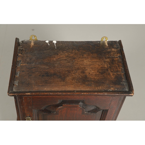 532 - A 17TH CENTURY OAK SPICE CUPBOARD. the panelled door revealing a pigeon hole interior and seven smal... 