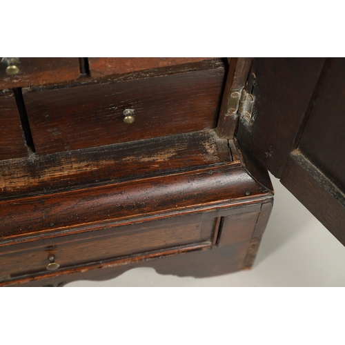 532 - A 17TH CENTURY OAK SPICE CUPBOARD. the panelled door revealing a pigeon hole interior and seven smal... 