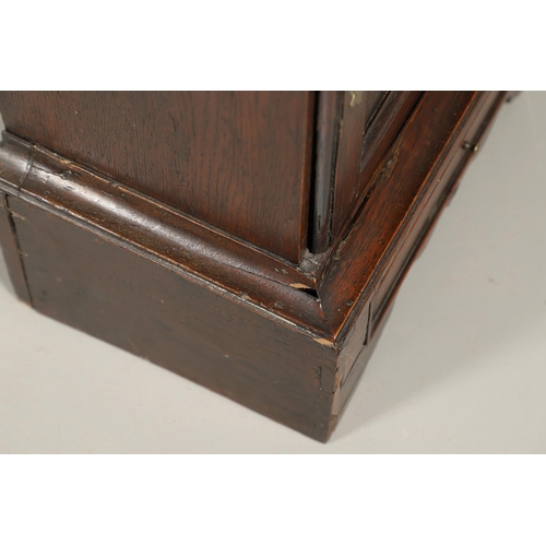 532 - A 17TH CENTURY OAK SPICE CUPBOARD. the panelled door revealing a pigeon hole interior and seven smal... 