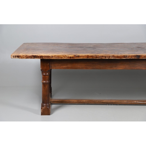 533 - AN EARLY 20TH CENTURY OAK AND ELM REFECTORY TABLE. the elm five plank top upon turned and block supp... 