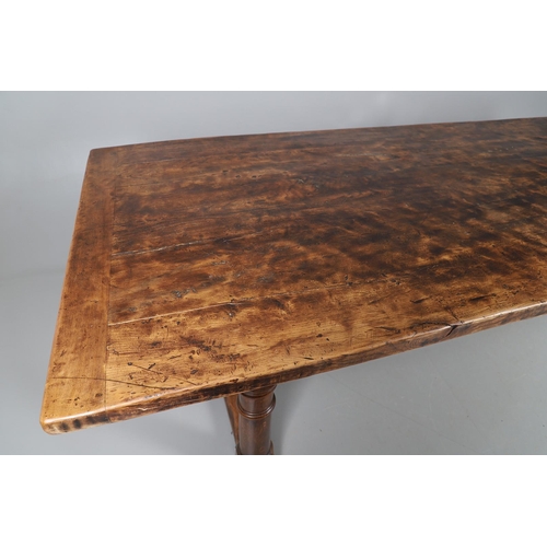 533 - AN EARLY 20TH CENTURY OAK AND ELM REFECTORY TABLE. the elm five plank top upon turned and block supp... 