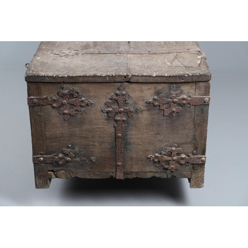 534 - A SUBSTANTIAL ANTIQUE OAK AND IRON STRAPWORK CHEST. the two plank lid and body bound with ornate str... 