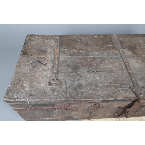 534 - A SUBSTANTIAL ANTIQUE OAK AND IRON STRAPWORK CHEST. the two plank lid and body bound with ornate str... 