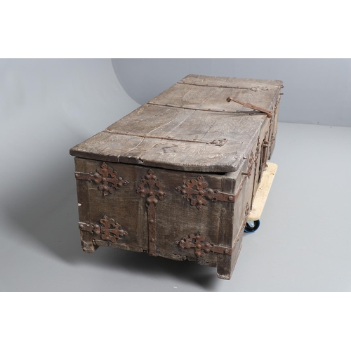 534 - A SUBSTANTIAL ANTIQUE OAK AND IRON STRAPWORK CHEST. the two plank lid and body bound with ornate str... 